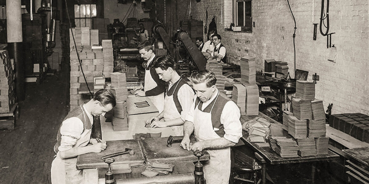 The men shown here are making book covers at American Bible Society’s former Astor Place location.