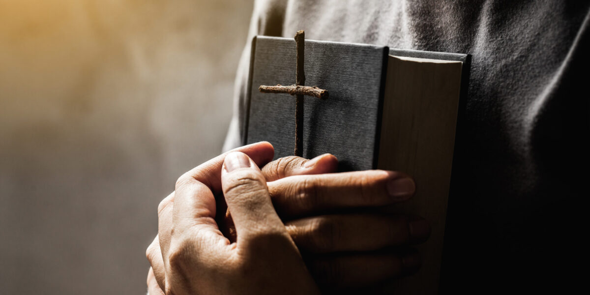 Women holding the Bible and Crosses of blessing from God.Women in religious concepts