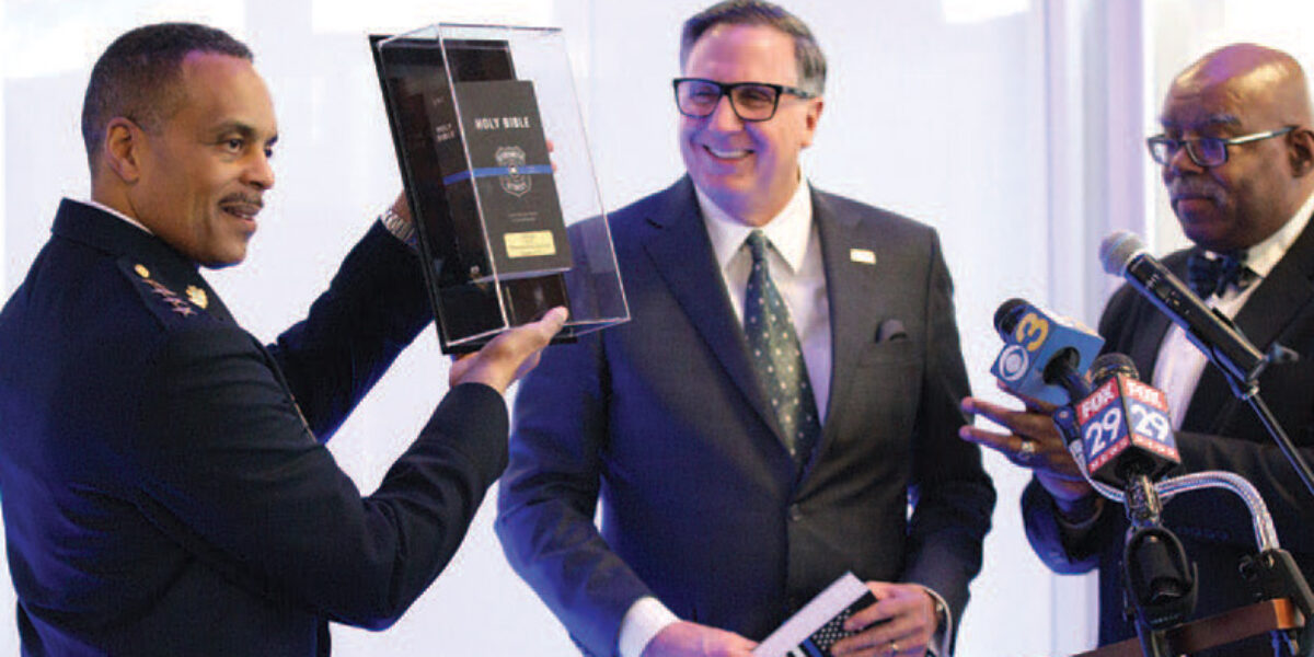 American Bible Society President & CEO Roy Peterson (center) presents a “Strength for the Streets” Bible to Philadelphia Police Commissioner Richard Ross Jr. (left). Photo credit: Doug Nottage.