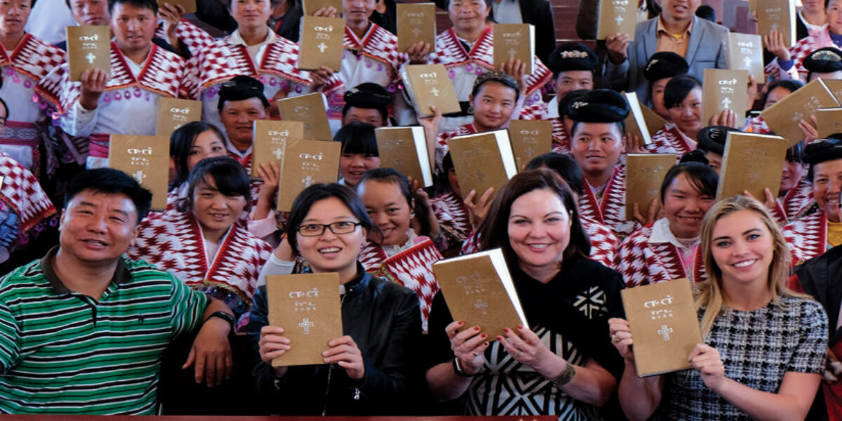 In October 2016, American Bible Society Board Member Cheryl Holland and her daughter Hannah (seated third and fourth in the front row) helped distribute newly translated Bibles to the Miao language group in rural China. Photo credits: Jared Wong.