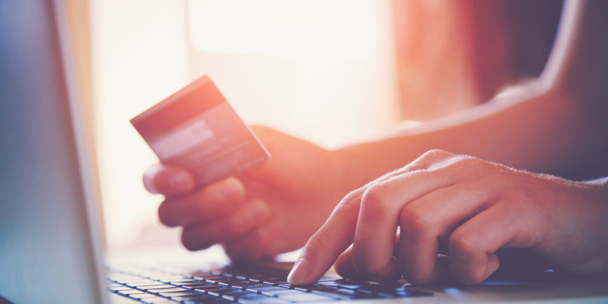 Hands,Holding,Credit,Card,And,Using,Laptop.,Online,Shopping