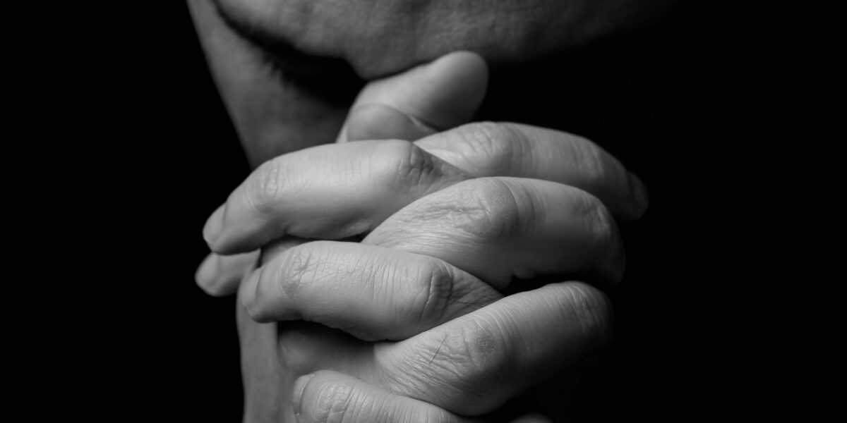 Close,Up,Of,Faithful,Mature,Man,Praying,,Hands,Folded,In