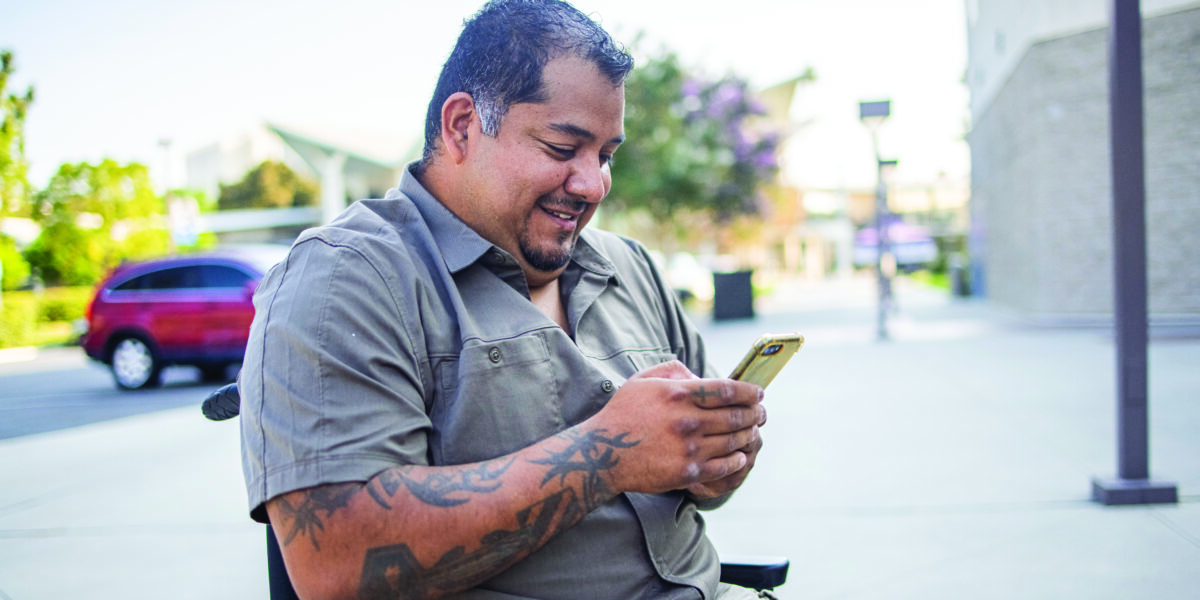 Hispanic American Veteran College Student Using Smartphone