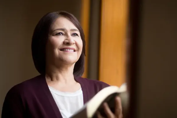Woman holding a book close to her chest