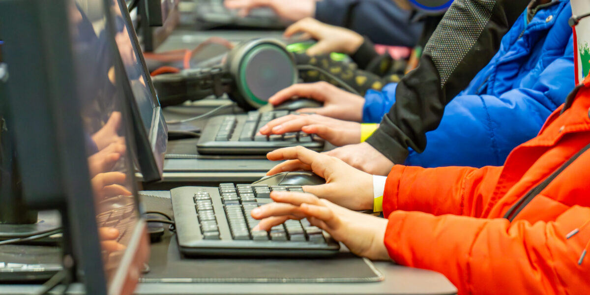 children playing computer games on laptops. computer games tournament. children’s game. fair competition.