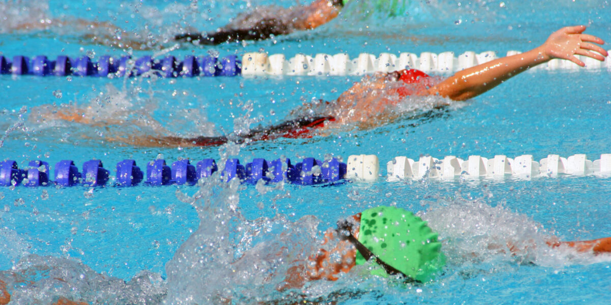 Backstroke swimmers in a close race